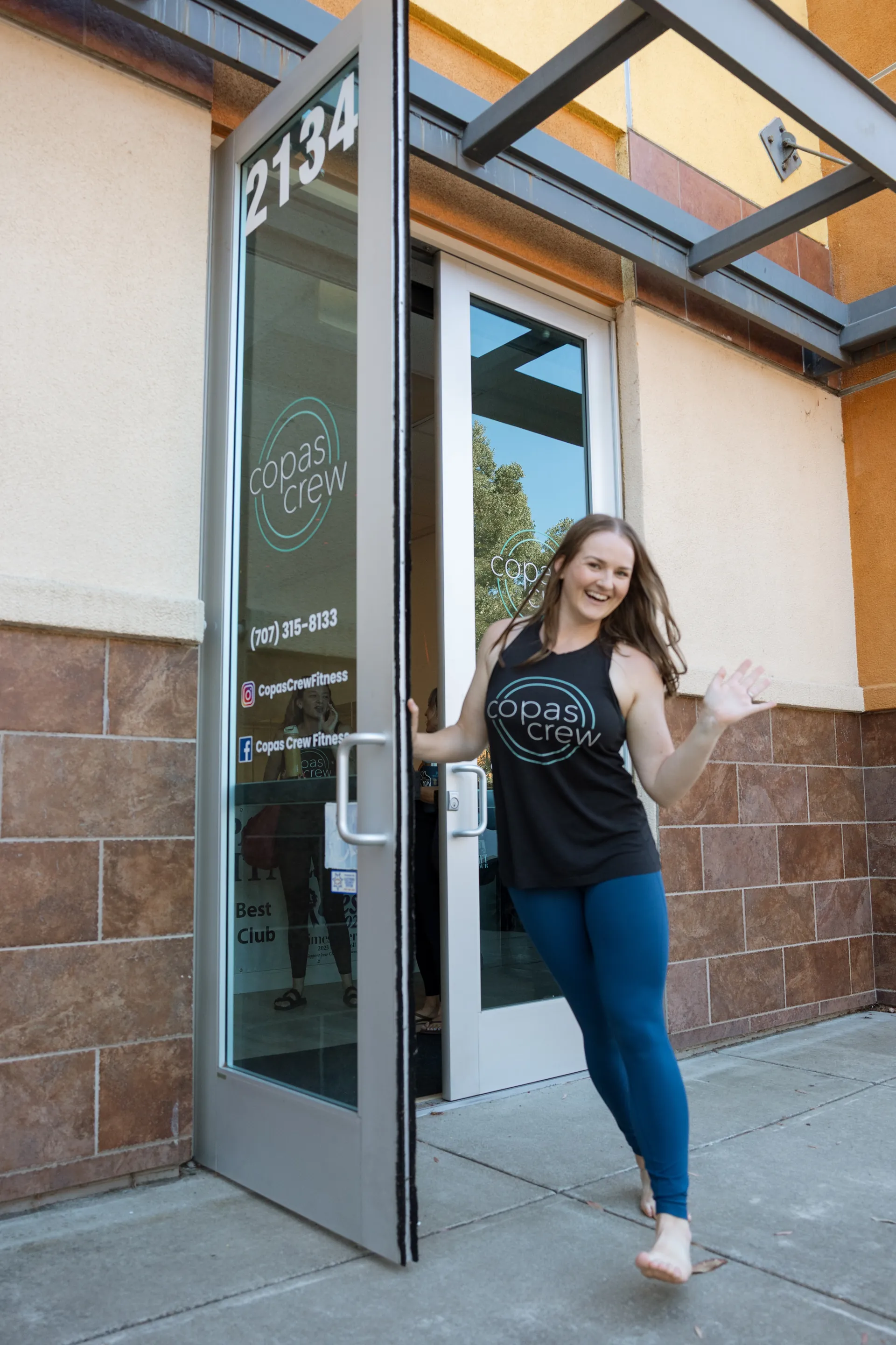 Kelsey waiving at Copas Crew Fitness